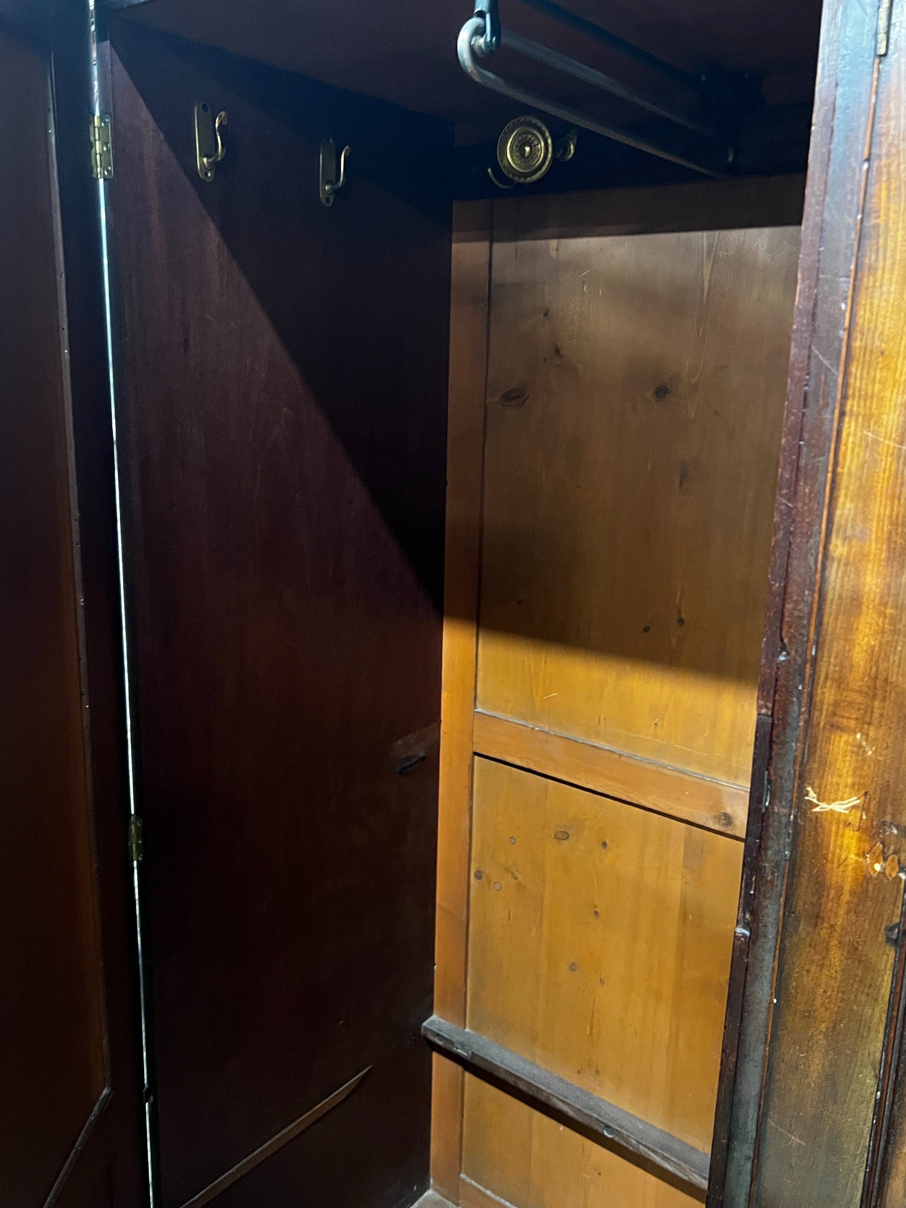 A late 18th century mahogany compactum wardrobe, fitted with three flame mahogany doors, length 217cm, depth 59cm, height 188cm